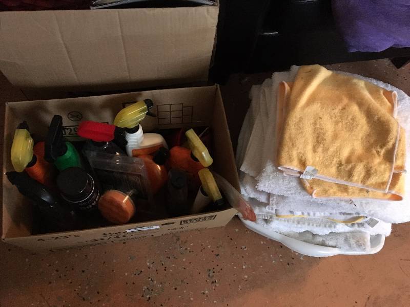 lot 1315 image: Auto Detailing Set - 12 Bottles of Armor All, Highlight Cleaner, Tire Gloss, Tub Full of Detailer Towels with Micro Fiber Towels
