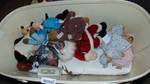 bassinet full of dolls and stuffed animals