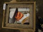 Wooden framed John Wayne picture.