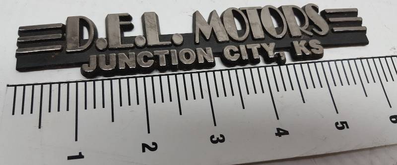 lot 5730 image: Chrome plastic with back adhesive D.E.L. Motors dealership tag for the trunk or fender