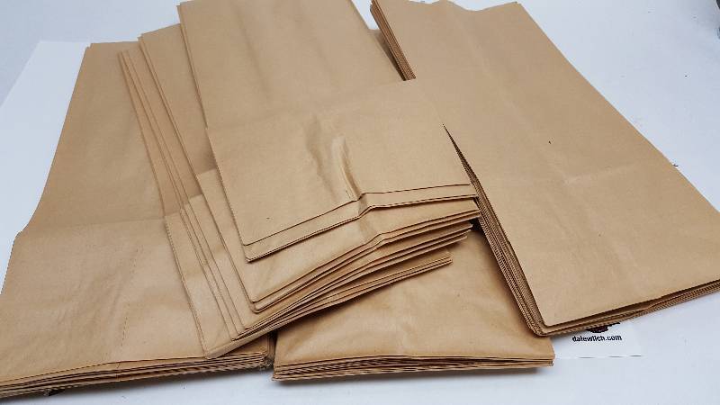 lot 5295 image: 50 new brown paper sacks that measure 6 X 13 and with the square bottom when opened.