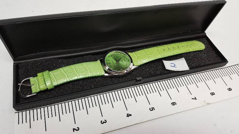 lot 5343-2 image: Cool looking and new in the plastic case is this colored costume watch
