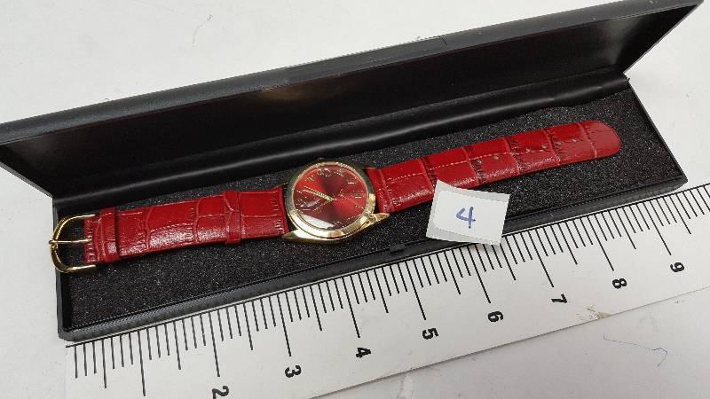 lot 5343-4 image: Cool looking and new in the plastic case is this colored costume watch