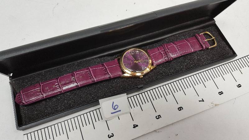 lot 5343-6 image: Cool looking and new in the plastic case is this colored costume watch