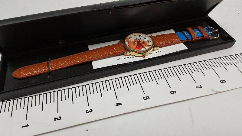 lot 5343 image: Cool looking and new in the plastic case is this colored costume watch