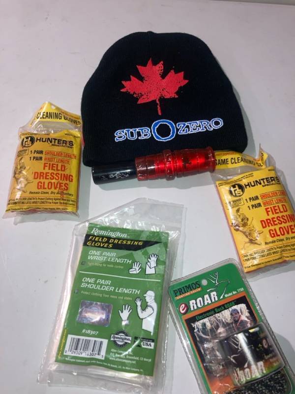 lot 32932 image: HUNTING CARE PACKAGE, FIELD 3 PAIRS OF DRESSING GLOVES,PRIMOS HUNTING CALLS ELECTRIC BUCK ROAR, DUCK CALL, SUB O ZERO BENNIE