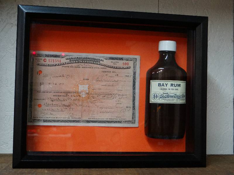lot 769 image: 1925 Original Prohibition Whiskey Prescription and Bay Rum Rexall Store Bottle in shadow box