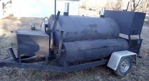 lot 1860 image: 14Ft Southern Yankee Commercial Smoker Trailer - Garage Kept Commercial Smoker with Over 6Ft Smoking Chamber, Six (6) Rack Rotating Rotisserie, Large Warming Chamber, Custom Grill in Front, Wood Rack in Back - Over $12k New