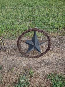 lot 1042 image: 25 inch across coil of barb wire with a large star in the center