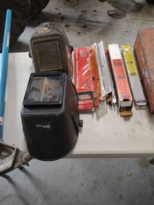 lot 1351 image: two welding helmets and welding rod