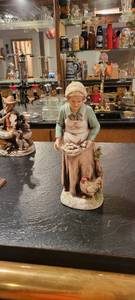 lot 2047 image: 10 inch statue of woman clicking eggs.