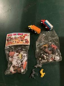 lot 3192 image: Two packages of farm animals and and two plastic trucks