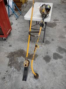 lot 1203 image: Ryobi weed eater with saw attachment