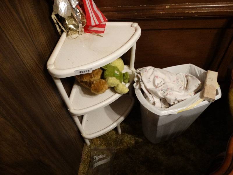 lot 12 image: Corner shelf, trash can.