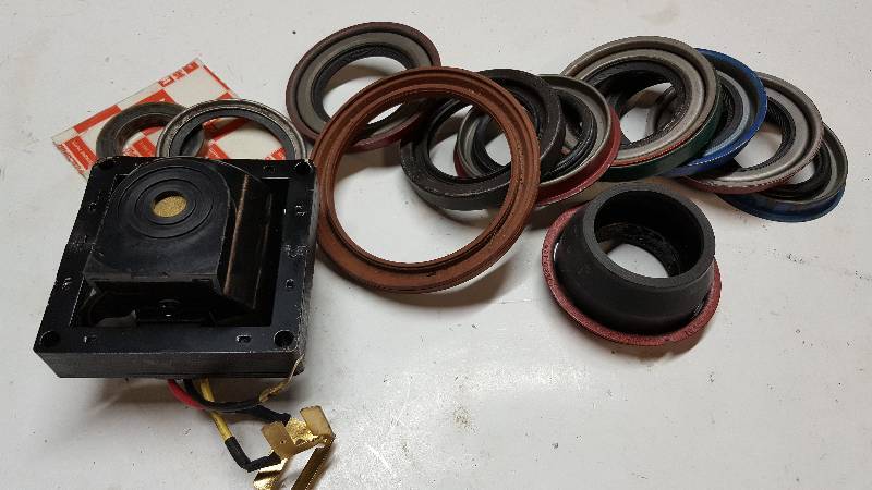 lot 5282 image: Assorted pieces for the mechanic.  New shaft seals and a new HEI GM distributor ignition internal coil.