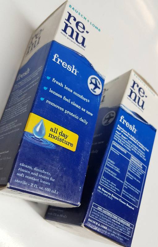 lot 5263 image: A pair of 2 fluid ounce bottles of the RE-Nu soft contact lens cleaner and disinfectant.