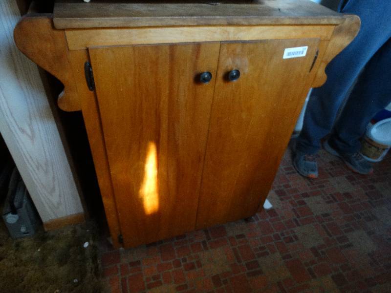 lot 558 image: Wood kitchen cabinet on wheels w contents