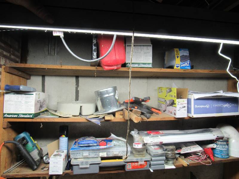 lot 6466 image: Contents of (2) shelves screws, clamps, hammer drill, fixtures