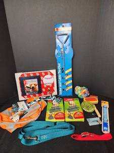 lot 283 image: New Pet Reflector Vest 2-3x, Waste Bags, New Tie Out, New Toys, New Pet Brush, (2) New Medium Dog Collars, New Leash and Training Clicker