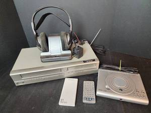 lot 377 image: Colby DVDCDMP3 Player with Remote, JVC FM Cordless Headphones, Emerson DVDVHS Player, and Miisso Power Bank