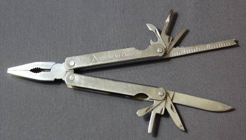 lot 9073 image: Vintage 4 American Camper Stainless Steel Folding Multi-Tool.