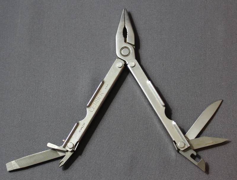 lot 9074 image: Vintage 4.5 Gerber Simonds USA Stainless Steel Folding Multi-Tool.