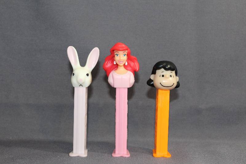 lot 9451 image: 3 PEZ Dispensers - White Bunny, Disney Ariel, Peanuts Lucy