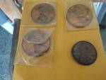 4 oversized novalty pennies.