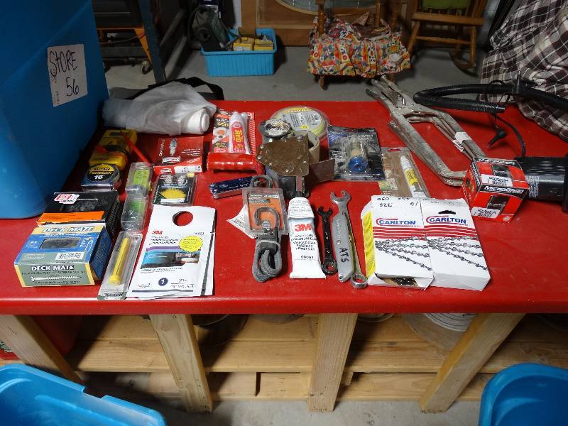lot 313 image: 2 chainsaw chains, spark plug, welding clamps, misc.