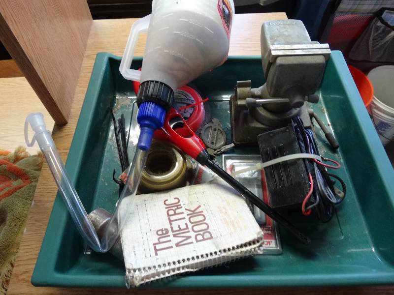 lot 961 image: Steel wire, trimmer line, battery charger, clamp and more.