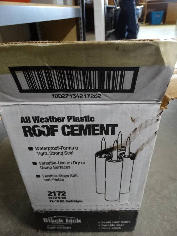 lot 995 image: Roof cement and a paint roller.