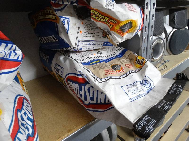 lot 1003 image: 1 full bag and 1 half bag of kingsford charcoal.