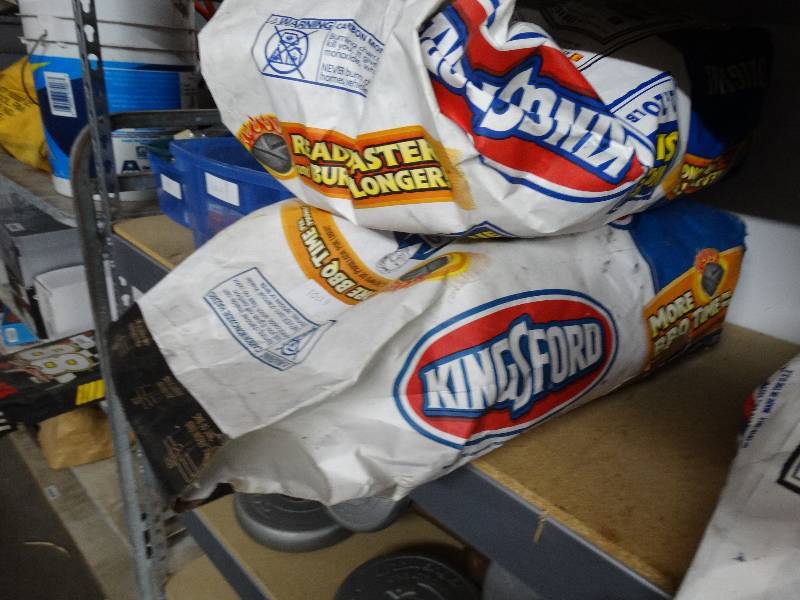 lot 1004 image: 1 full bag and 1 half bag of kingsford charcoal.