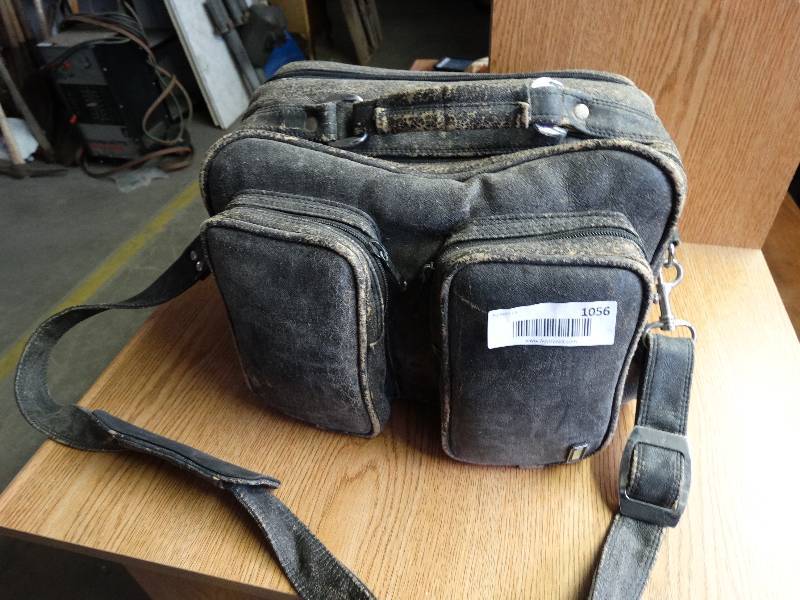lot 1056 image: Canon camera with spare lenses in camera bag.