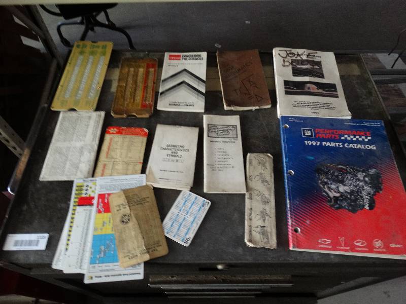 lot 1104 image: Mathematical charts, note pads, GM parts catalog.