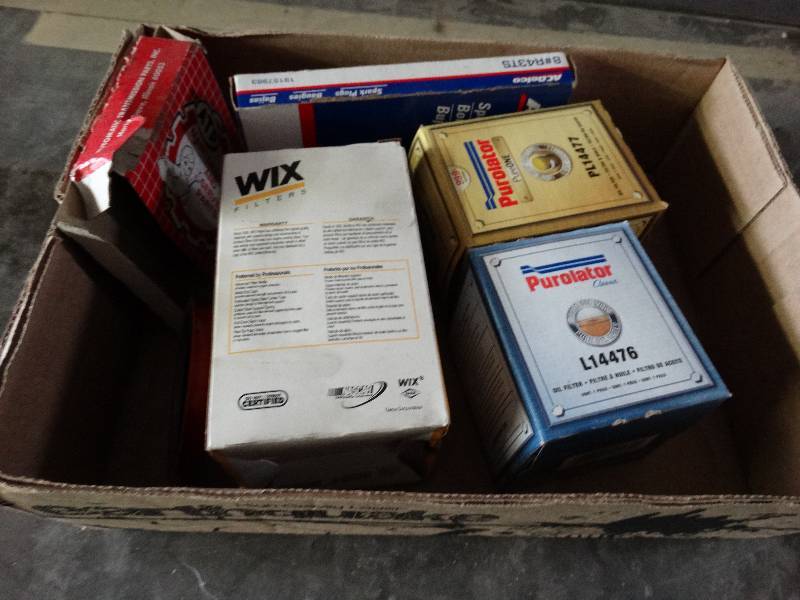 lot 1114 image: Oil filters and spark plugs.