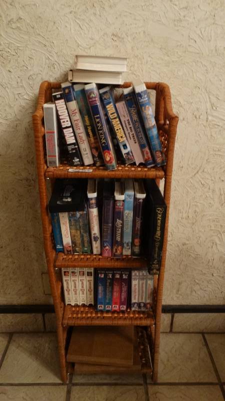 lot 115 image: Wicker shelf w various VHS tapes