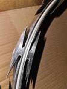 lot 58 image: Unused Department Of Corrections Surplus - DOC & DOD Grade - Allied Tube & Conduit Helical Razor Ribbon Brand Barbed Tape (Wire) - 18 HEL 33LSSGA 50ft Roll Retail $1023.58 Per Roll