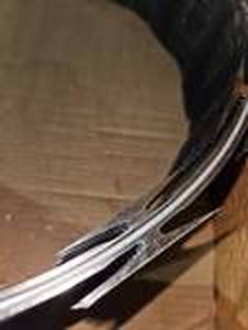 lot 87 image: Unused Department Of Corrections Surplus - DOC & DOD Grade - Allied Tube & Conduit Helical Razor Ribbon Brand Barbed Tape (Wire) - 18 HEL 33LSSGA 50ft Roll Retail $1023.58 Per Roll