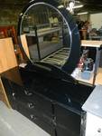 black dresser with round mirror