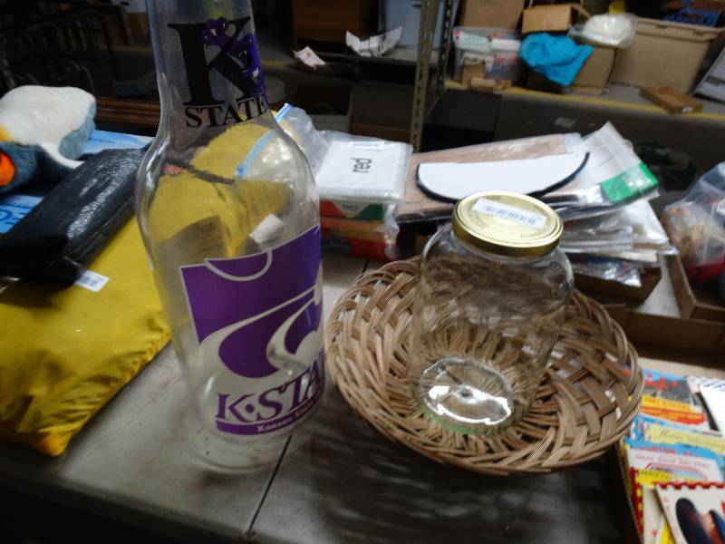 lot 779 image: Large K state plastic bottle, glass pickle jar, and wicker basket.