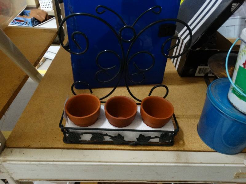 lot 806 image: Metal planters and OFF candles.