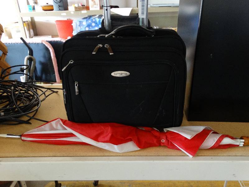 lot 823 image: Samsonite travel bag and umbrella.