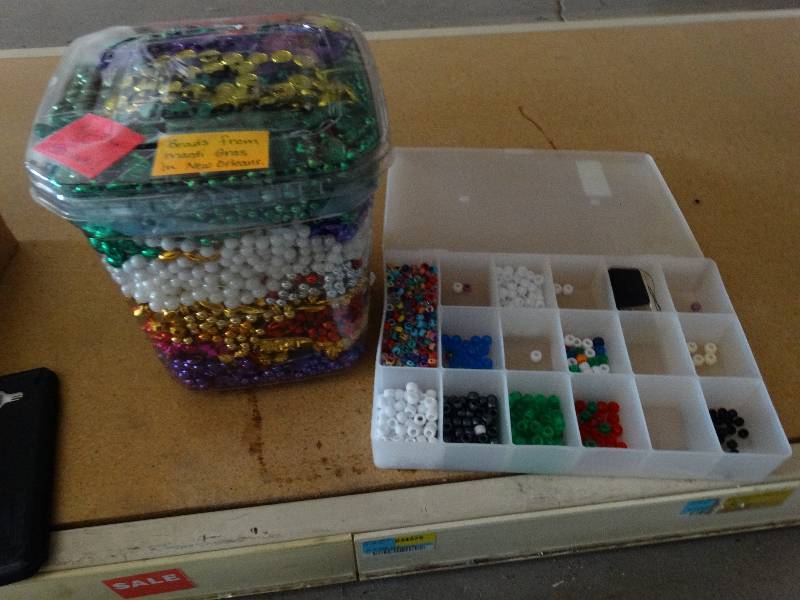 lot 848 image: Lot of Mardi gras bead strands and beads in container.
