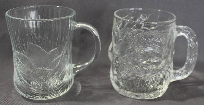 lot 9755 image: Set of Two Clear Glass Mugs - Arcoroc with Canterbury Design & Luminarc Santa