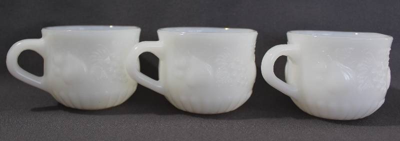 lot 9757 image: Set of Three Milk Glass Tea Cups with Fruit Design.