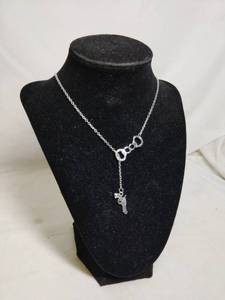 lot 579 image: Handcuffs and Gun Necklace