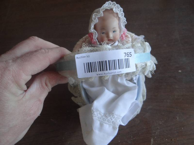 lot 765 image: Small vintage porcelain baby in basket.