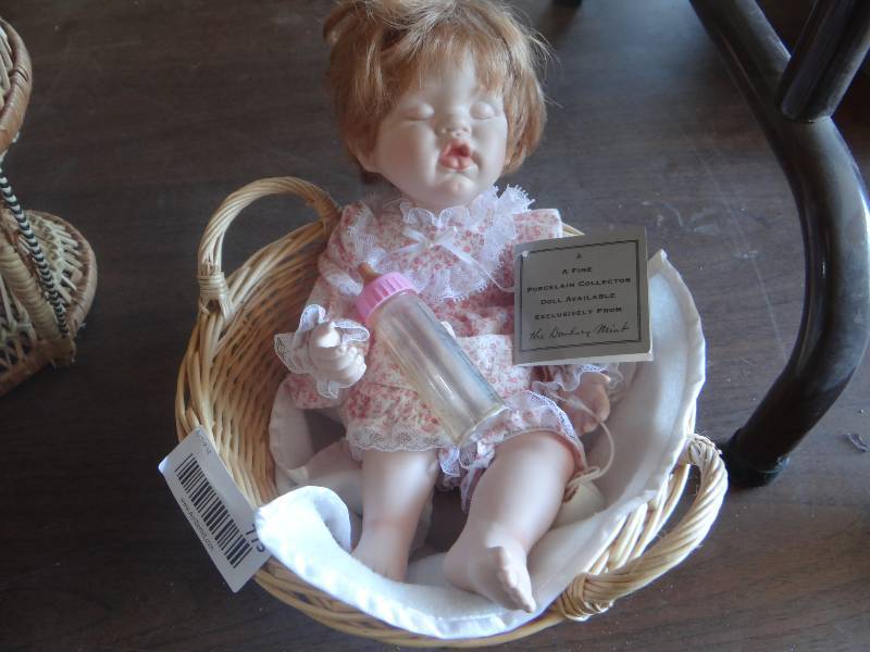 lot 775 image: Porcelain baby doll sleeping in basket.