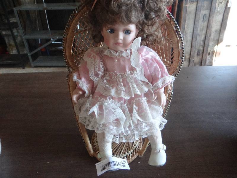 lot 776 image: Porcelain baby doll in chair.